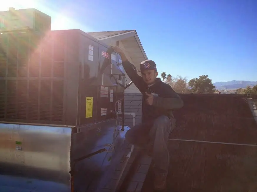 HVAC technician performing HVAC Inspection on a rooftop unit in Collingdale